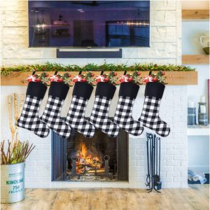 Urban Farmhouse decor ideas as buffalo check stockings in front of a fireplace with birch logs