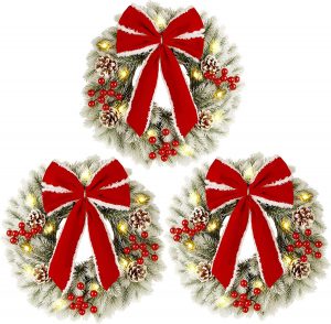 Three frosted wreaths with big red bows