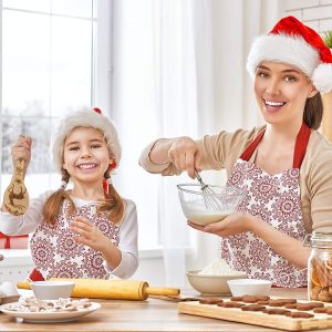 A mother and daughter duo cooking Christmas treats with holiday utensils